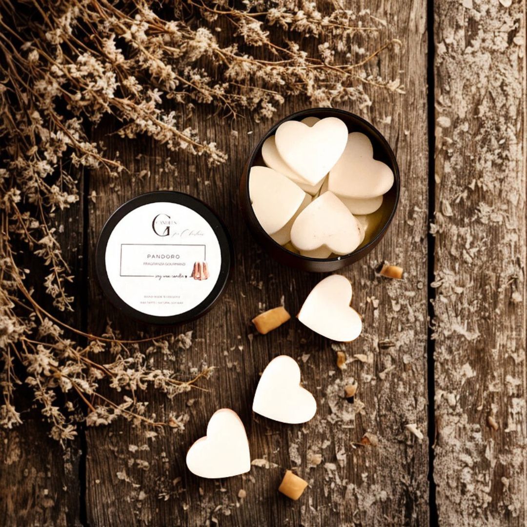 Candele artigianali in cera di soia a forma di cuore su sfondo in legno naturale